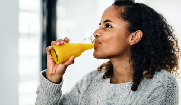 woman-drinking-fresh-orange-juice-PVDTHCL